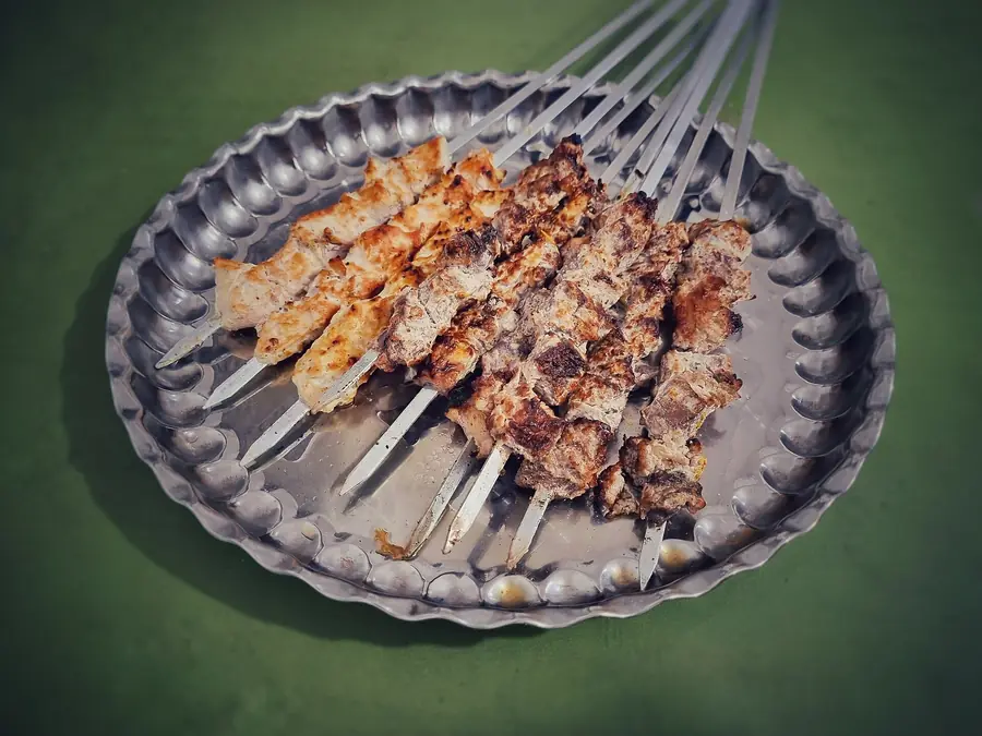 Kebab skewers grilling over open flame